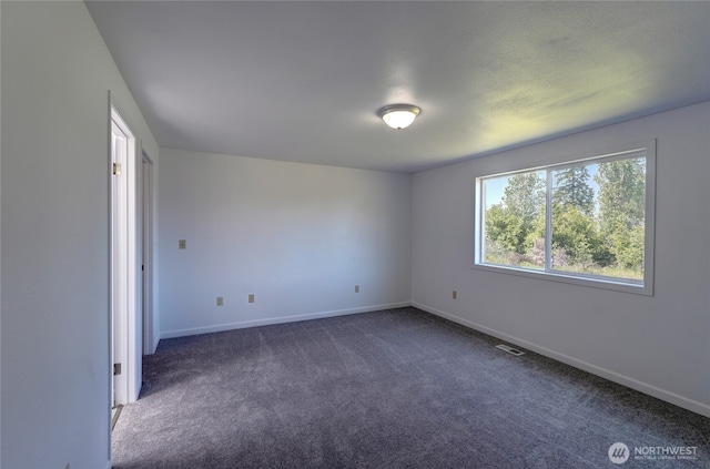 2320 183rd Street Ct E, Tacoma, WA 98445 - empty room featuring dark colored carpet and baseboards