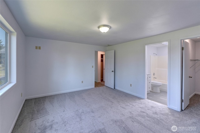 2320 183rd Street Ct E, Tacoma, WA 98445 - unfurnished bedroom featuring carpet, a walk in closet, baseboards, and connected bathroom