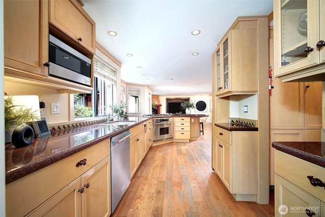 2120 Squak Mountain Loop SW, Issaquah, WA 98027 - kitchen featuring appliances with stainless steel finishes, dark stone countertops, recessed lighting, light wood-style floors, and glass insert cabinets