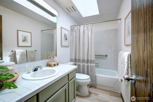 2120 Squak Mountain Loop SW, Issaquah, WA 98027 - full bath with wood finished floors, toilet, vanity, a skylight, and shower / tub combo with curtain