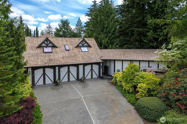 2120 Squak Mountain Loop SW, Issaquah, WA 98027 - tudor-style house featuring concrete driveway and stucco siding
