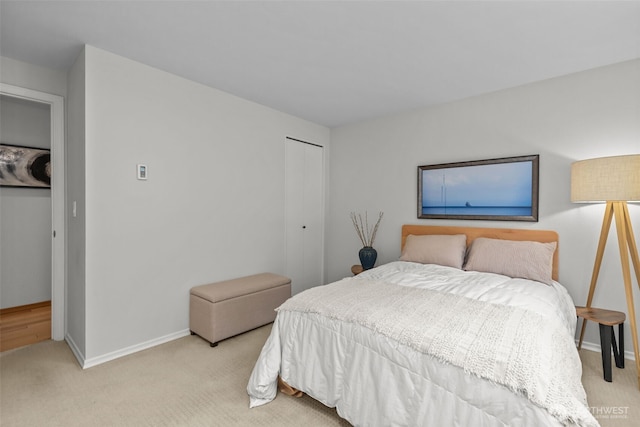 4222 Beach Dr SW Unit 303, Seattle, WA 98116 - bedroom featuring light carpet, a closet, and baseboards