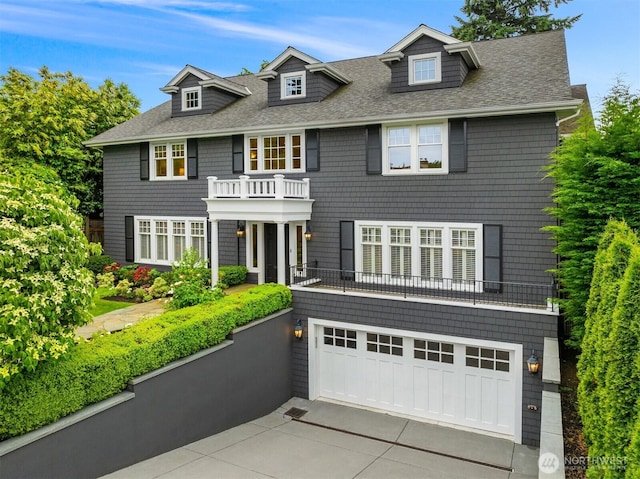 1325 Broadmoor Dr E, Seattle, WA 98112 - view of front of property featuring concrete driveway, a shingled roof, a balcony, and a garage