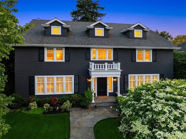 1325 Broadmoor Dr E, Seattle, WA 98112 - view of front facade with roof with shingles, a yard, and a balcony