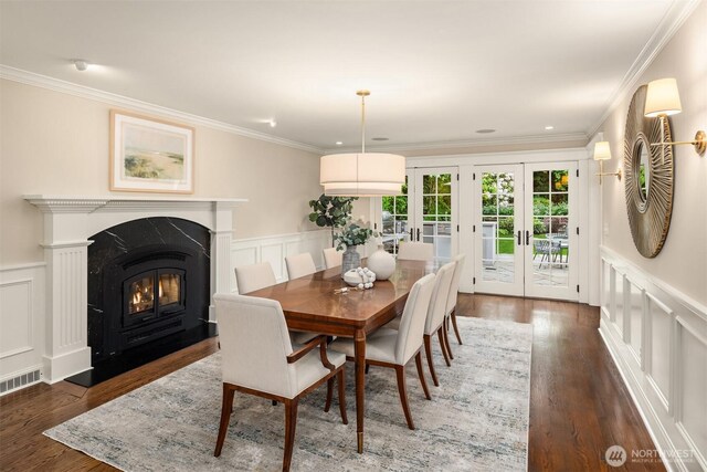 1325 Broadmoor Dr E, Seattle, WA 98112 - dining area with french doors, a decorative wall, a high end fireplace, crown molding, and wood finished floors
