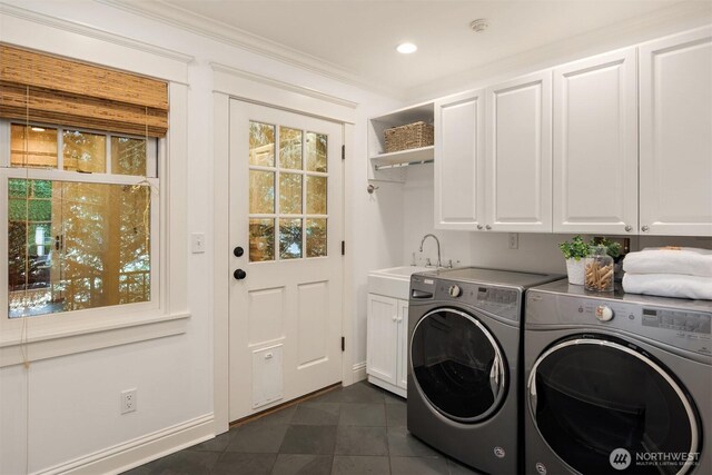 1325 Broadmoor Dr E, Seattle, WA 98112 - laundry room with cabinet space, washer and clothes dryer, dark tile patterned flooring, baseboards, and crown molding