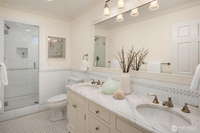 1325 Broadmoor Dr E, Seattle, WA 98112 - full bathroom featuring crown molding, a shower stall, toilet, double vanity, and tile walls