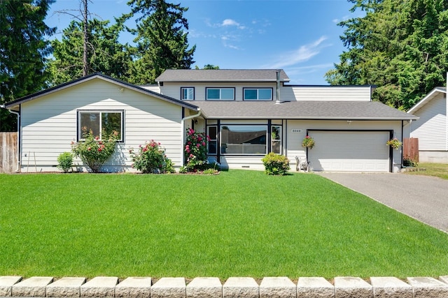 8048 S Ainsworth Ave, Tacoma, WA 98408 - view of front of house with a garage, asphalt driveway, a front yard, and a shingled roof