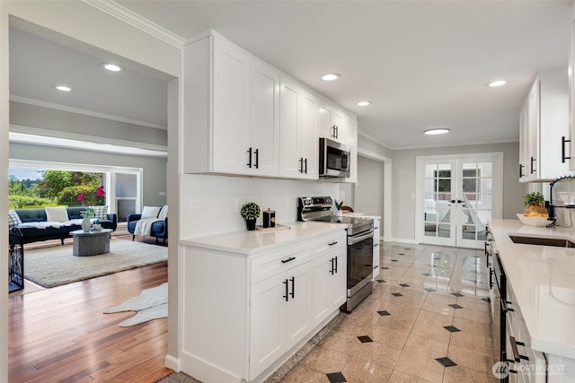 8048 S Ainsworth Ave, Tacoma, WA 98408 - kitchen with stainless steel appliances, a sink, crown molding, french doors, and recessed lighting