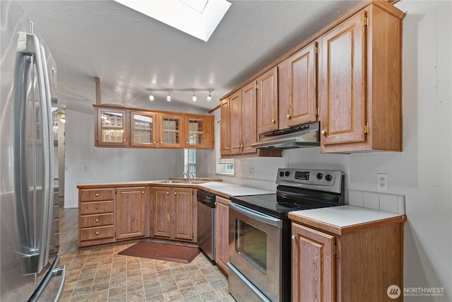 8530 Steilacoom Rd SE Unit 113, Olympia, WA 98513 - kitchen with stainless steel appliances, under cabinet range hood, a skylight, a sink, and light countertops