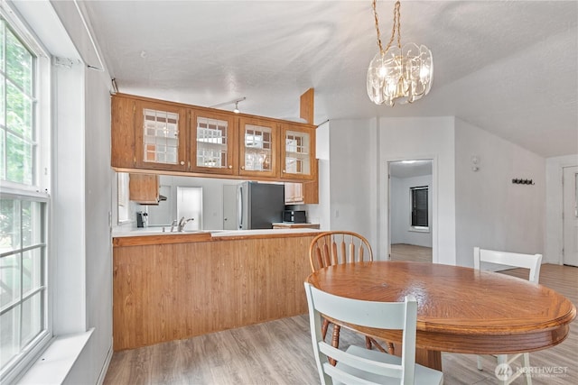 8530 Steilacoom Rd SE Unit 113, Olympia, WA 98513 - dining space with light wood-type flooring, a chandelier, and lofted ceiling