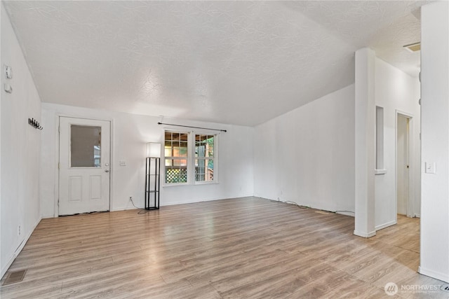 8530 Steilacoom Rd SE Unit 113, Olympia, WA 98513 - unfurnished living room featuring light wood-style floors, a textured ceiling, and baseboards