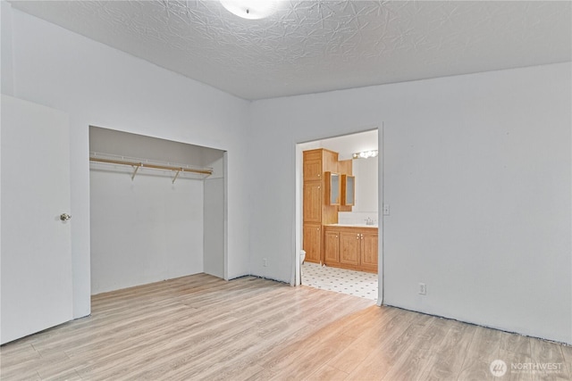 8530 Steilacoom Rd SE Unit 113, Olympia, WA 98513 - unfurnished bedroom featuring light wood-style flooring, a closet, and ensuite bath