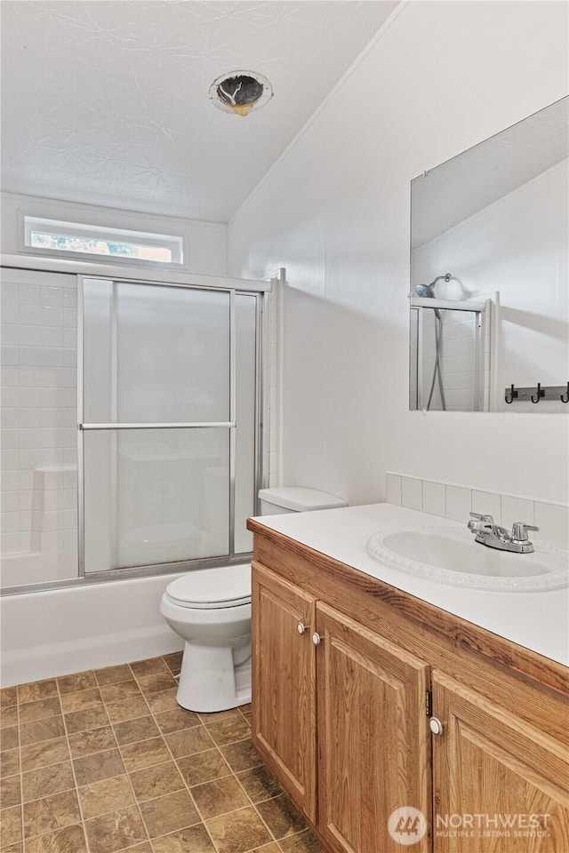 8530 Steilacoom Rd SE Unit 113, Olympia, WA 98513 - full bathroom featuring vanity, toilet, and shower / bath combination with glass door