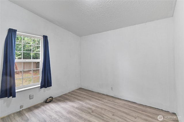 8530 Steilacoom Rd SE Unit 113, Olympia, WA 98513 - empty room featuring vaulted ceiling and wood finished floors