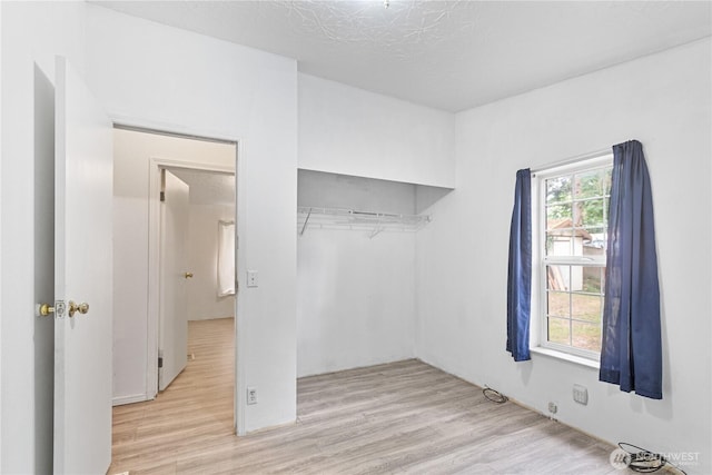 8530 Steilacoom Rd SE Unit 113, Olympia, WA 98513 - unfurnished bedroom featuring wood finished floors and a closet