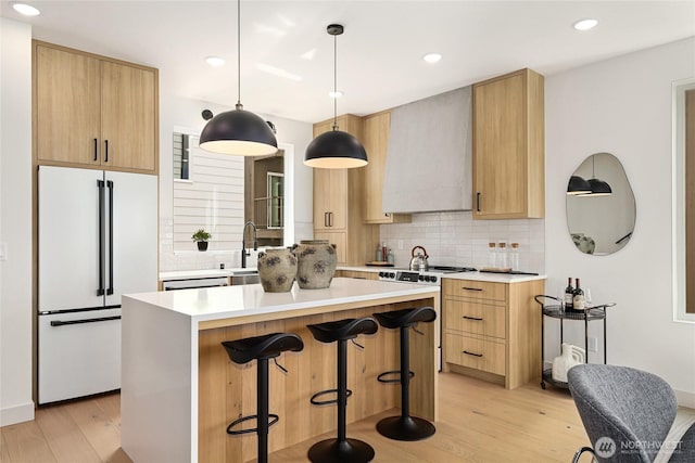 4515 44th Ave SW Unit A, Seattle, WA 98116 - kitchen featuring white refrigerator, range with electric cooktop, custom range hood, light brown cabinets, and recessed lighting