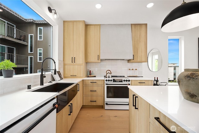 4515 44th Ave SW Unit A, Seattle, WA 98116 - kitchen with light brown cabinetry, white appliances, light countertops, decorative backsplash, and recessed lighting
