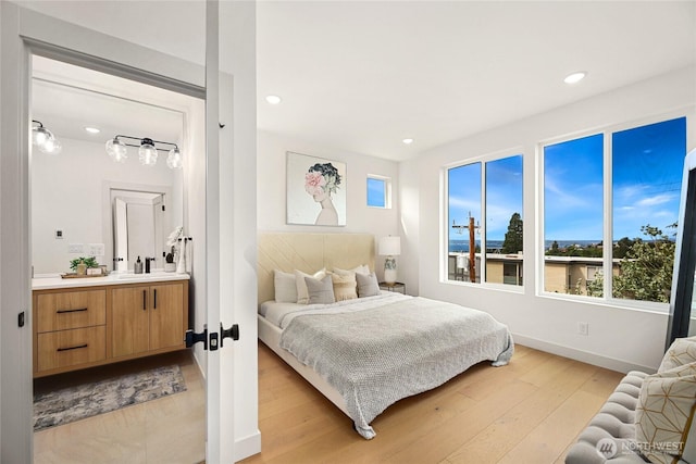 4515 44th Ave SW Unit A, Seattle, WA 98116 - bedroom with light wood-style flooring, recessed lighting, and baseboards