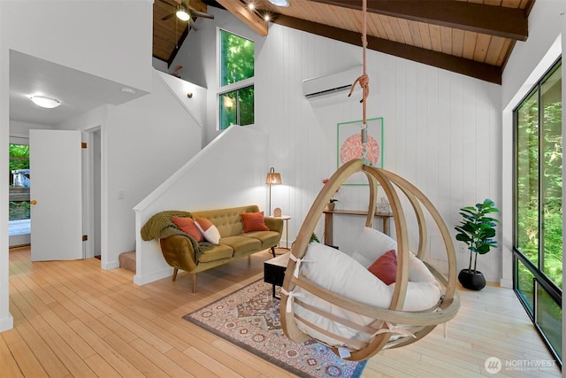 22 Bramble Way, Bellingham, WA 98229 - living room with plenty of natural light, a wood ceiling with exposed beams, a wall unit AC, wood finished floors, and high vaulted ceiling