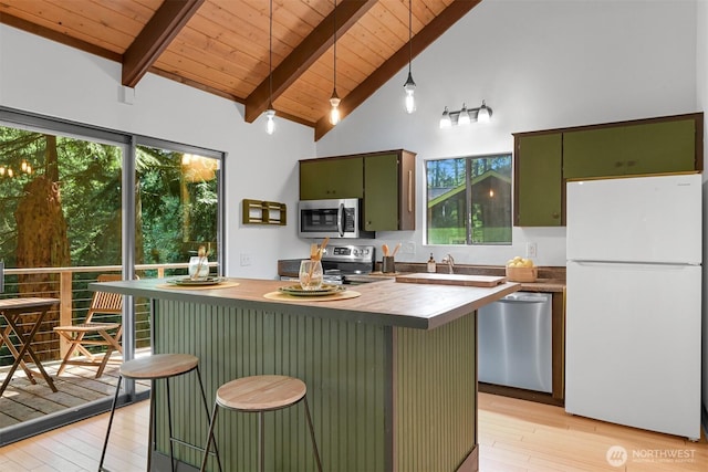 22 Bramble Way, Bellingham, WA 98229 - kitchen featuring appliances with stainless steel finishes, green cabinetry, light wood-style flooring, a wooden ceiling with exposed beams, and a kitchen island