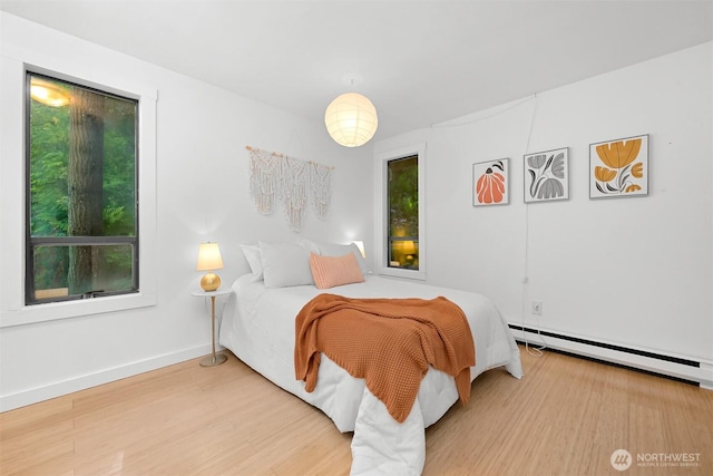 22 Bramble Way, Bellingham, WA 98229 - bedroom with a baseboard radiator, wood finished floors, and multiple windows