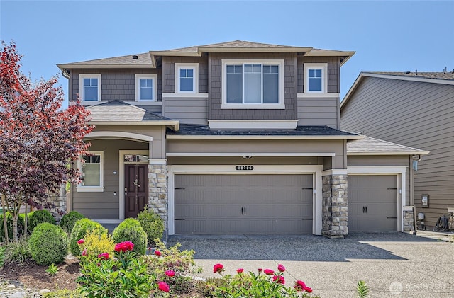 12726 36th Pl NE, Lake Stevens, WA 98258 - view of front of house featuring stone siding, concrete driveway, a garage, and roof with shingles