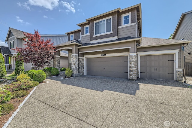 12726 36th Pl NE, Lake Stevens, WA 98258 - view of front of house with stone siding, driveway, a garage, and roof with shingles