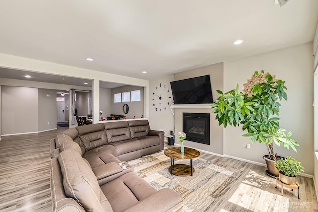 12726 36th Pl NE, Lake Stevens, WA 98258 - living area featuring wood finished floors, a glass covered fireplace, recessed lighting, and baseboards