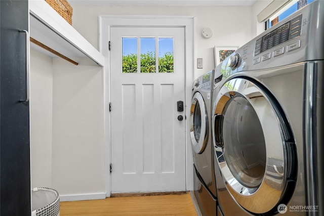 4742 22nd Ave SW, Seattle, WA 98106 - washroom featuring washer and clothes dryer, light wood-type flooring, and baseboards
