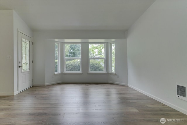 2539 123rd Ave SW, Olympia, WA 98512 - unfurnished room featuring wood finished floors, baseboards, and heating unit