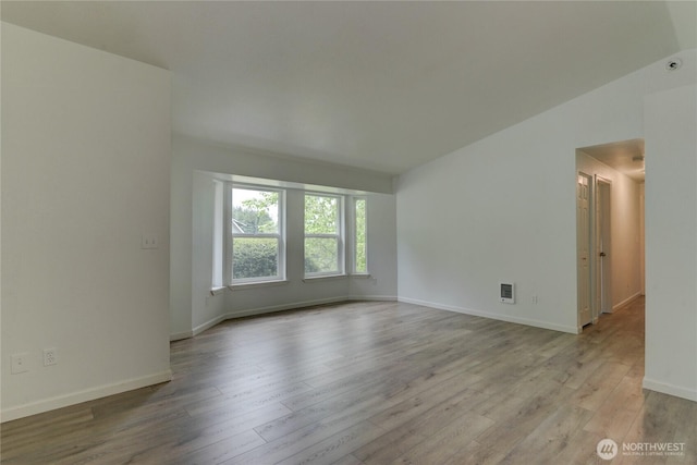 2539 123rd Ave SW, Olympia, WA 98512 - spare room featuring wood finished floors, baseboards, and lofted ceiling