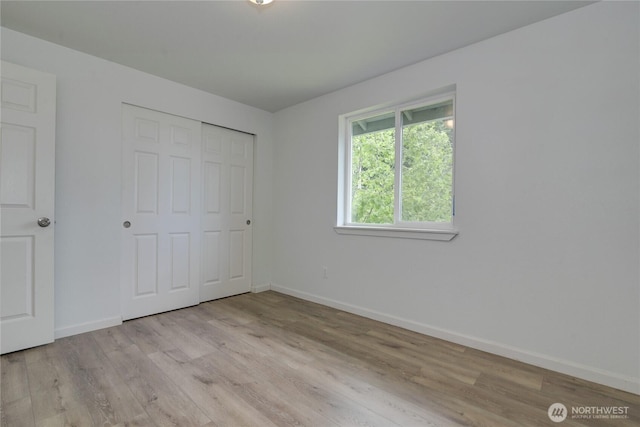 2539 123rd Ave SW, Olympia, WA 98512 - unfurnished bedroom featuring baseboards, light wood finished floors, and a closet