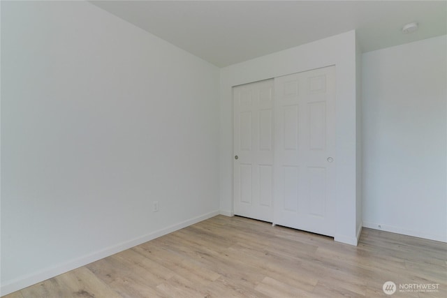 2539 123rd Ave SW, Olympia, WA 98512 - unfurnished bedroom featuring light wood-style floors, baseboards, and a closet