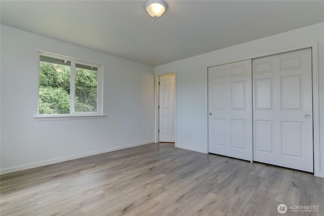 2539 123rd Ave SW, Olympia, WA 98512 - unfurnished bedroom featuring light wood-style floors, a closet, and baseboards