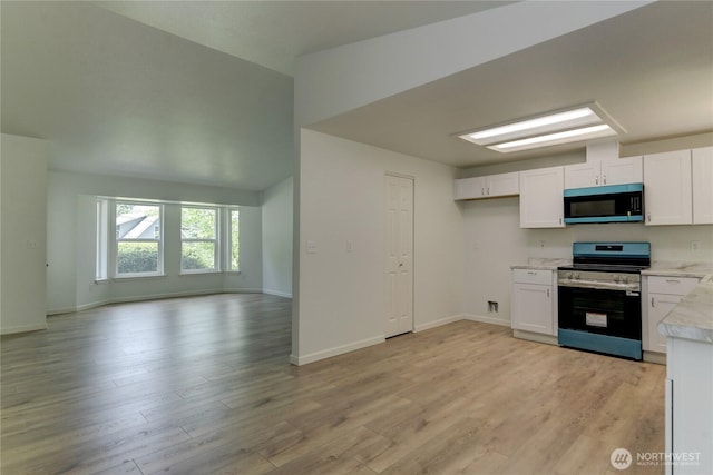 2539 123rd Ave SW, Olympia, WA 98512 - kitchen featuring stainless steel range with electric stovetop, open floor plan, light countertops, and white cabinets