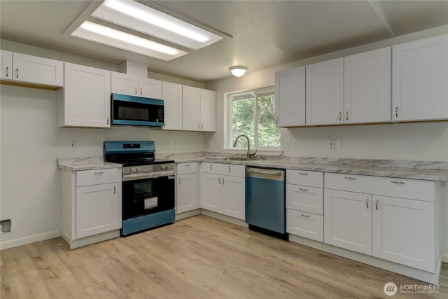 2539 123rd Ave SW, Olympia, WA 98512 - kitchen with dishwasher, black microwave, electric stove, light wood-style floors, and white cabinetry