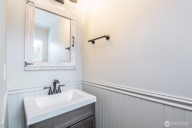 6628 Carolina St SE, Olympia, WA 98513 - bathroom with a wainscoted wall, vanity, and a decorative wall