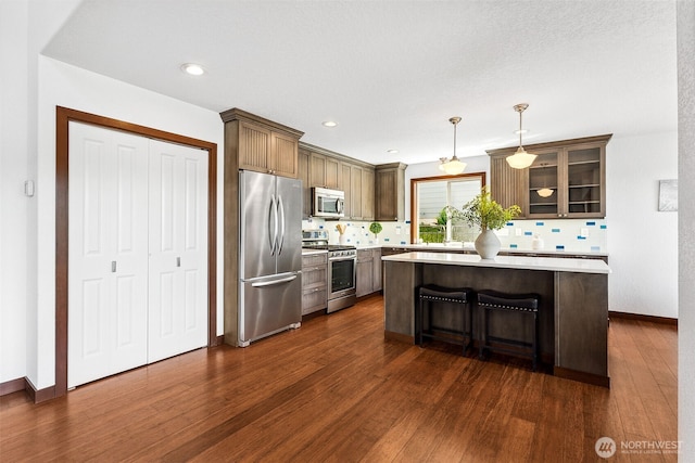 931 Oyster Bay Ct, Bremerton, WA 98312 - kitchen with appliances with stainless steel finishes, tasteful backsplash, dark wood finished floors, and recessed lighting