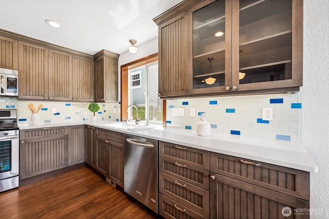 931 Oyster Bay Ct, Bremerton, WA 98312 - kitchen featuring appliances with stainless steel finishes, backsplash, dark wood-style floors, and glass insert cabinets