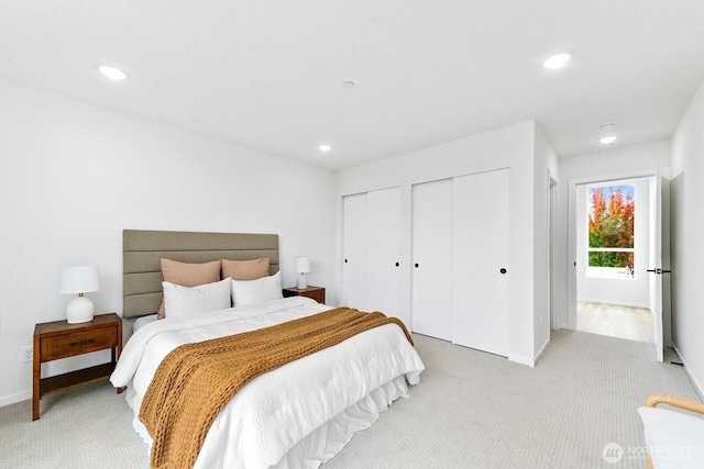 8324 16th Ave NW Unit A, Seattle, WA 98117 - bedroom with light carpet, multiple closets, recessed lighting, and baseboards