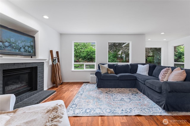 1906 Lion Pl, Wenatchee, WA 98801 - living area featuring wood finished floors, a brick fireplace, recessed lighting, and baseboards