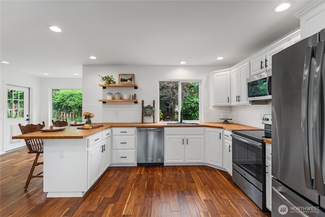 1906 Lion Pl, Wenatchee, WA 98801 - kitchen with stainless steel appliances, butcher block counters, a sink, a peninsula, and recessed lighting