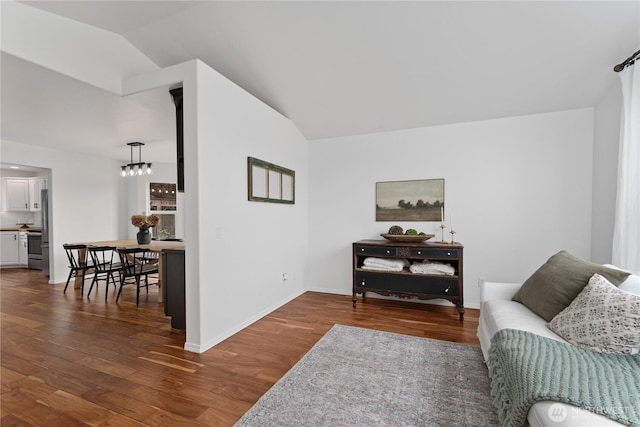 1906 Lion Pl, Wenatchee, WA 98801 - living room with vaulted ceiling, dark wood-style floors, baseboards, and a chandelier