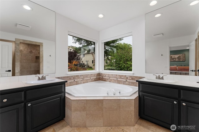 1906 Lion Pl, Wenatchee, WA 98801 - ensuite bathroom with healthy amount of natural light, two vanities, a bath, and recessed lighting