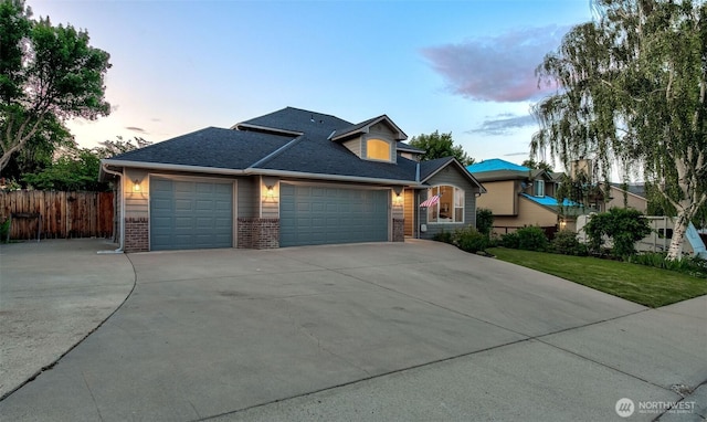 1906 Lion Pl, Wenatchee, WA 98801 - traditional-style home with a garage, concrete driveway, brick siding, and a shingled roof