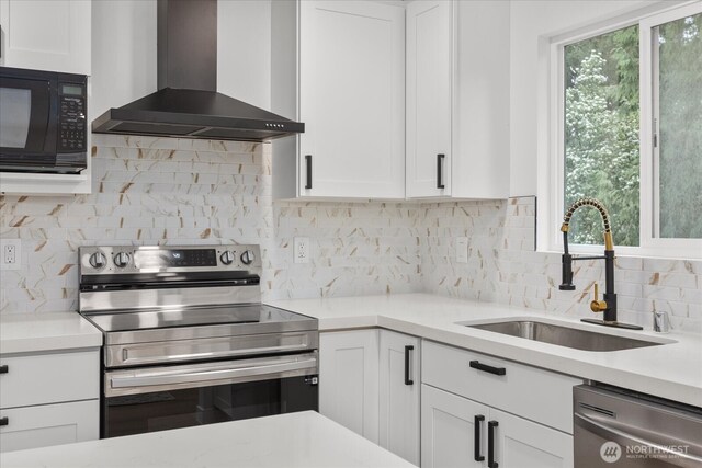 16514 Wallingford Ave N, Shoreline, WA 98133 - kitchen with wall chimney exhaust hood, appliances with stainless steel finishes, a sink, light countertops, and white cabinets