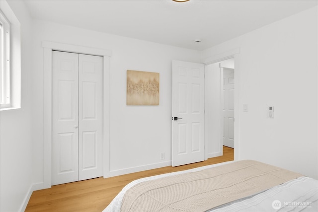 16514 Wallingford Ave N, Shoreline, WA 98133 - bedroom with light wood-style flooring, a closet, and baseboards
