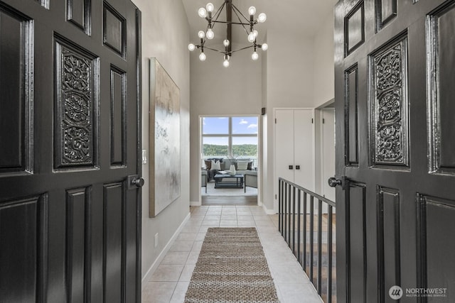 5110 NW Sammamish Rd, Issaquah, WA 98027 - foyer entrance with a high ceiling, light tile patterned floors, a chandelier, and baseboards