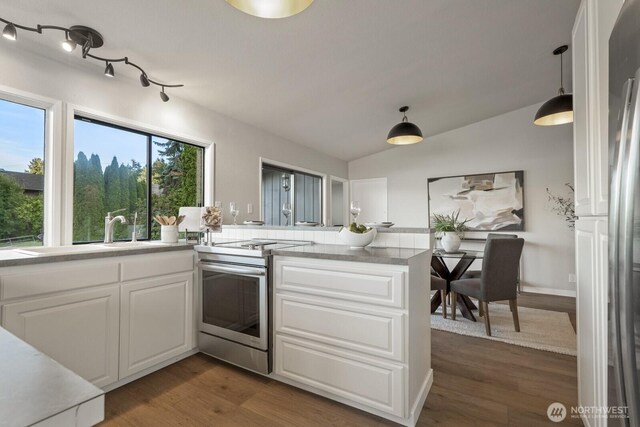 5110 NW Sammamish Rd, Issaquah, WA 98027 - kitchen featuring stainless steel range with electric stovetop, a peninsula, white cabinetry, dark wood finished floors, and light countertops